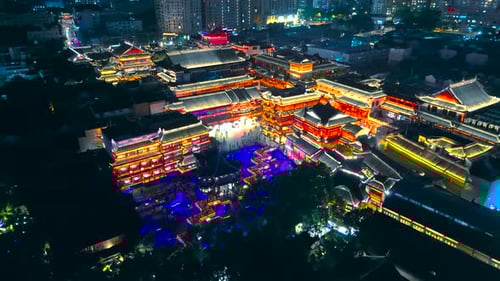 Night aerial of brightly lit traditional style buildings