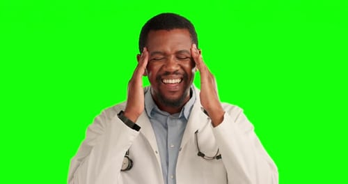 Stress, headache and male doctor in a studio with green screen for burnout or overworked