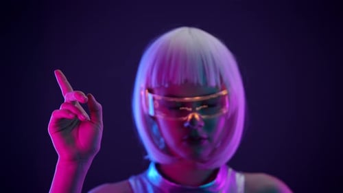 Futuristic Woman Using Virtual Interface in Neon Light