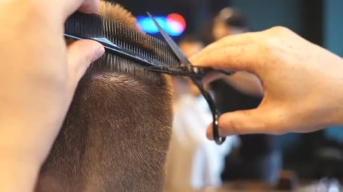 Haircut in progress at salon, close up view