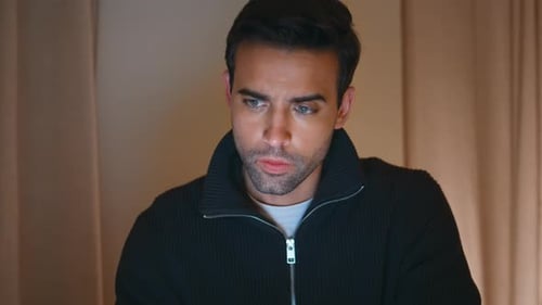 Serious Programmer Focused Laptop in Modern Home Office at Evening Closeup