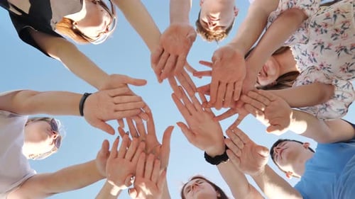 Young Adults Unite Hands for Friendship and Teamwork