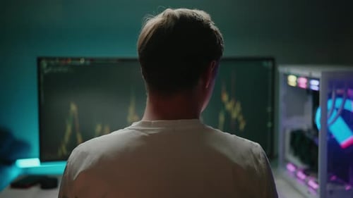 Rear View of Stock Trader Scratching Head While Watching Realtime Stock Market Data on Multiple