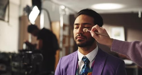 Man Getting Makeup Applied in a Studio