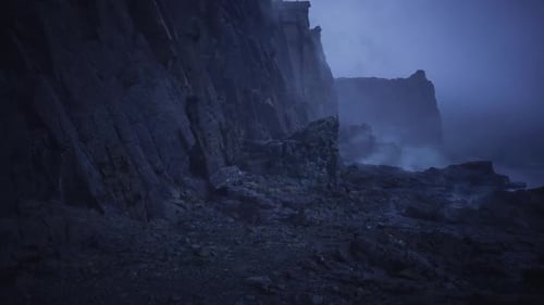 Hazy Landscape with Jagged Rocks and Reflective Tidal Pools Visible