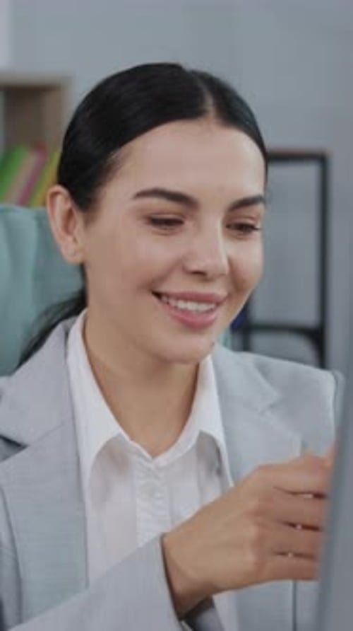 Young Woman Smiles Using Smartphone Inside