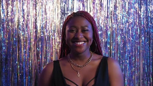 Smiling Woman in Front of Shimmering Fringe