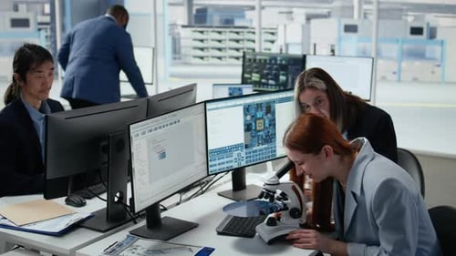 Reviewing Semiconductor Substrate Structures Microscope and Woman in Office