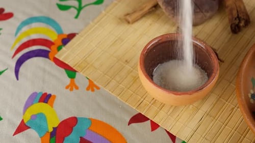 Adding Sugar to Small Clay Bowl Preparation