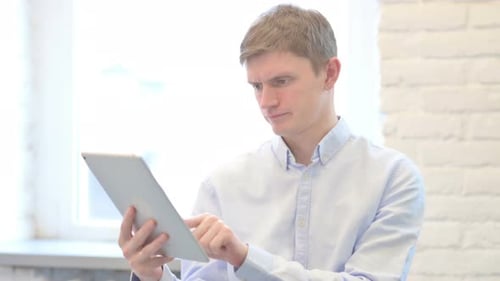 Young Adult Interacting with a Tablet Device