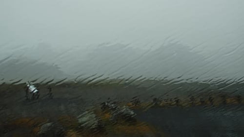 Wide view of Icelandic landscape through a car window in a heavy storm
