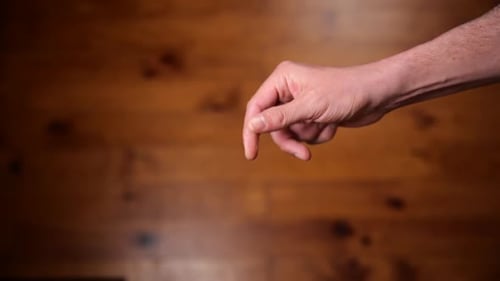 Tossing coin to flip on heads or tails and catch it on the fly. Slow-motion