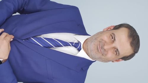 Confident Man in Blue Suit Posing in Vertical Video