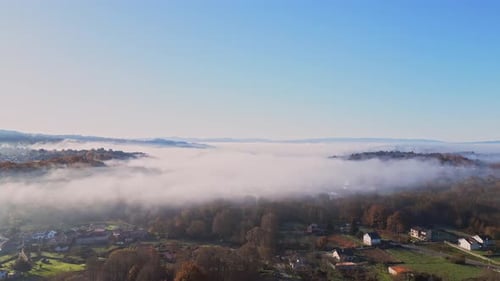Beautiful Aerial Shot Of Dense Fog Covering Small Villages And Big Forest
