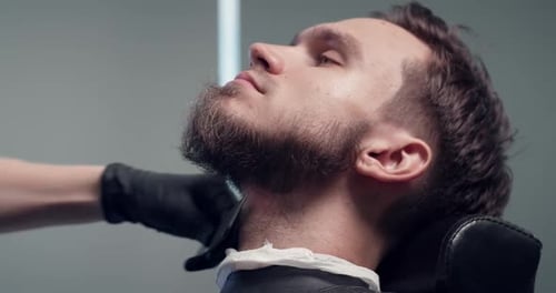 Man Getting Beard Trimmed at Barber Shop Close Up