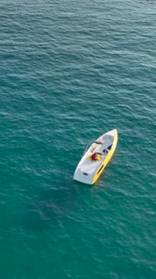Small Boat on Turquoise Water From Above