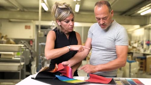 couple of professional fashion designer working together choosing the right pantone colour