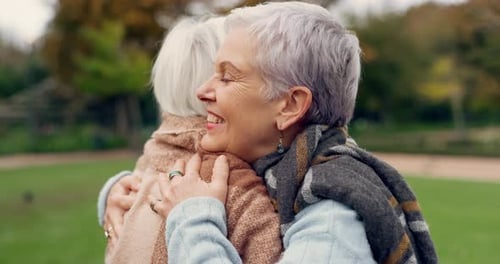 Senior Women Affectionately Hugging in Urban Park