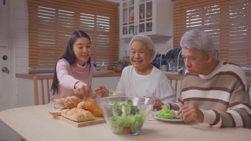 Family Eating Lunch and Talking in Kitchen