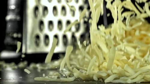 The Grated Cheese Falls on the Table Filmed on a Highspeed Camera at 1000 Fps