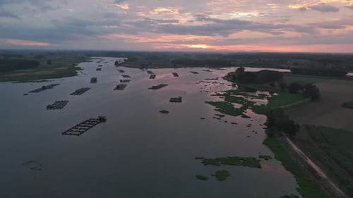 Aerial View Of A River With Structures At Sunset Calm Water And Nature