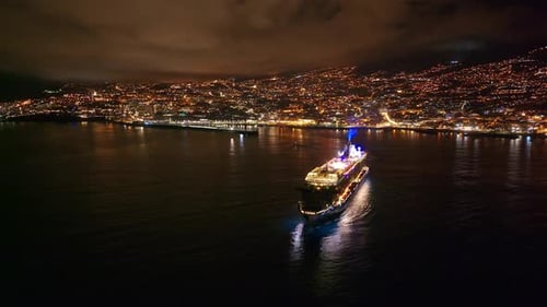Luxury cruise ship illuminated at night in Funchal Madeira harbor