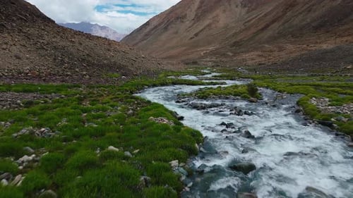 Aerial View of River Flowing Through Mountain Valley