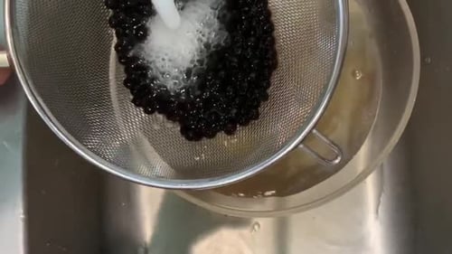 Tapioca balls also known as "boba pearls" used for hot and cold beverages. Rinsing under cold water