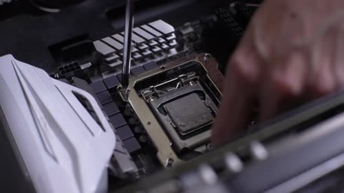 Closeup Highangle View of Unrecognizable Man Removing Screws Fixing Desktop PC Processor to