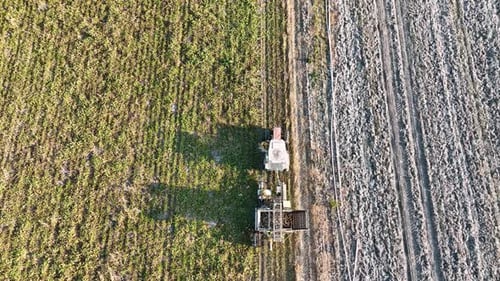 Harvesting Equipment Working in Rural Agricultural Field