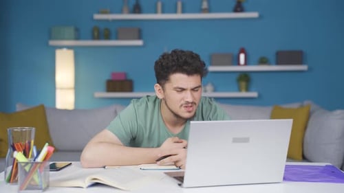 Male student suffering from back pain.