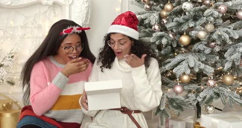 Multiracial Girls Unpacking Christmas Presents at Home