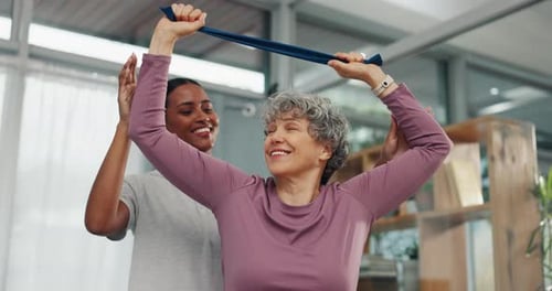 Personal Trainer Helping Senior Woman Exercise at Home