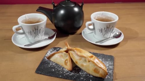 Tea and Pastries Still Life on Wooden Table