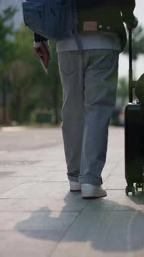 Latin Male Traveler Standing Still with Passport and Suitcase in Urban Area