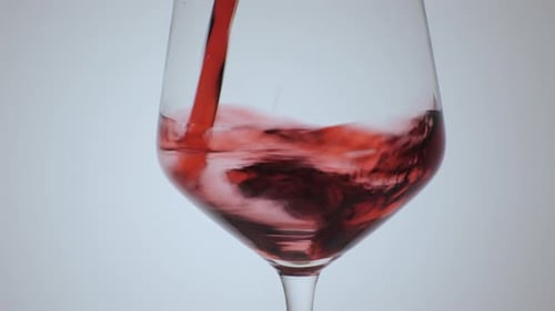 Pouring Red Wine into a Clear Wine Glass