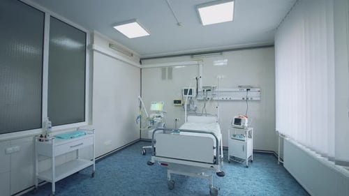 Modern ward of intensive care unit. Hospital room with bed and medical equipment in clinic.