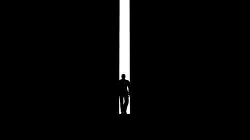 Silhouette of a Man Walking Towards Light