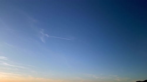 Beautiful sky gradient from golden yellow to dark blue hour sky with clouds
