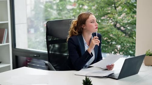 in a Modern Office with a Large Window a Beautiful Worker in a Blue Shirt with a Laptop Young Boss