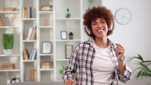 Woman Listening to Music and Dancing Indoors