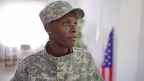 Woman in Military Uniform Posing Indoors