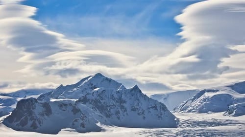 Majestic Snow-Capped Mountains Under Dynamic Cloud Formations