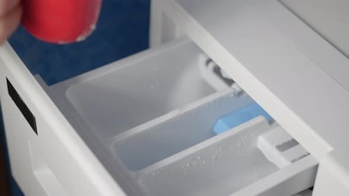 Pouring Laundry Detergent Powder Into Washing Machine