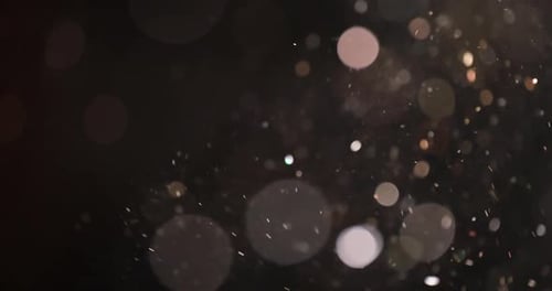 Sparkling Bokeh Light Particles on a Dark Background