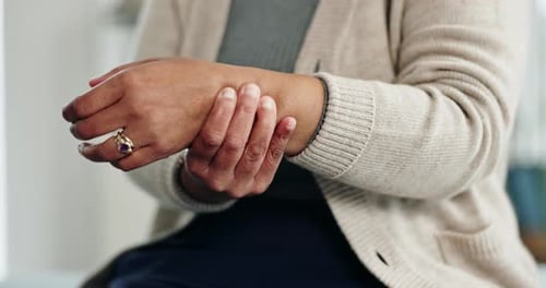 Woman Rubbing Sore Wrist Close Up