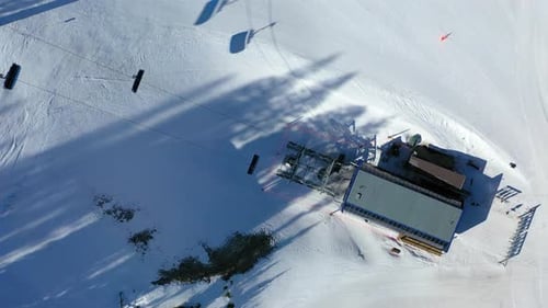 Ski Lift in Motion Above Powdery Trails and Forested Alpine Terrain