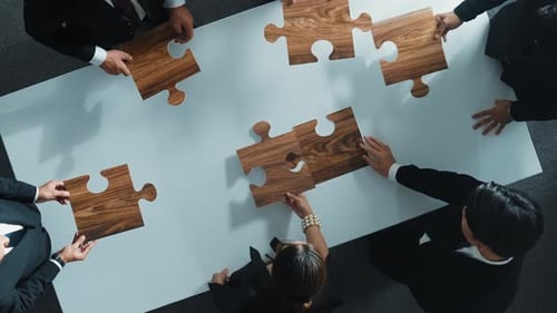 Top view of businesspeople putting jigsaw together at meeting room. Directorate.