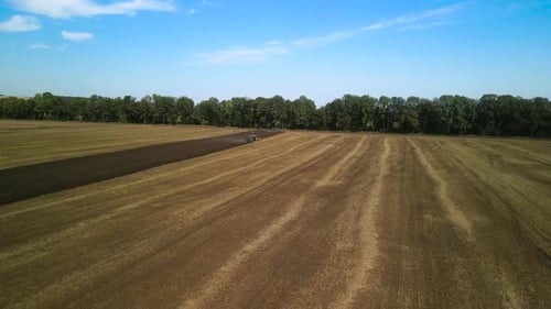 Tractors plowing the field in Ukraine