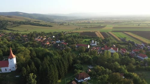 Flying above countryside village houses. Aerial drone view, Bikfalva, Bicfalau, Szeklerland, Romania